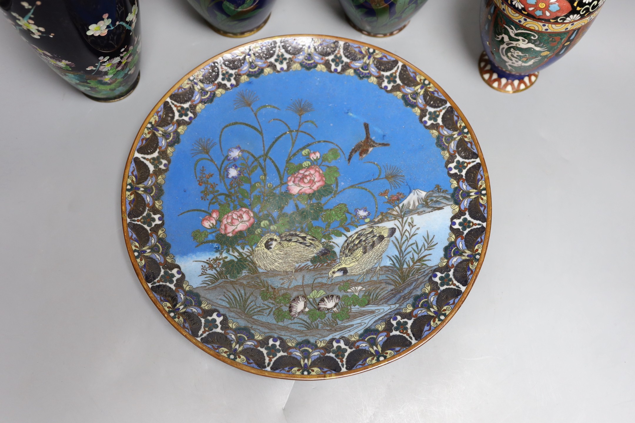 A group of Japanese cloisonné enamel wares to include a pair of vases, two other vases and a dish, Meiji period